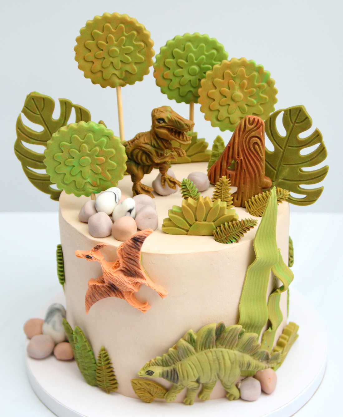 Dinosaur figures on a birthday cake