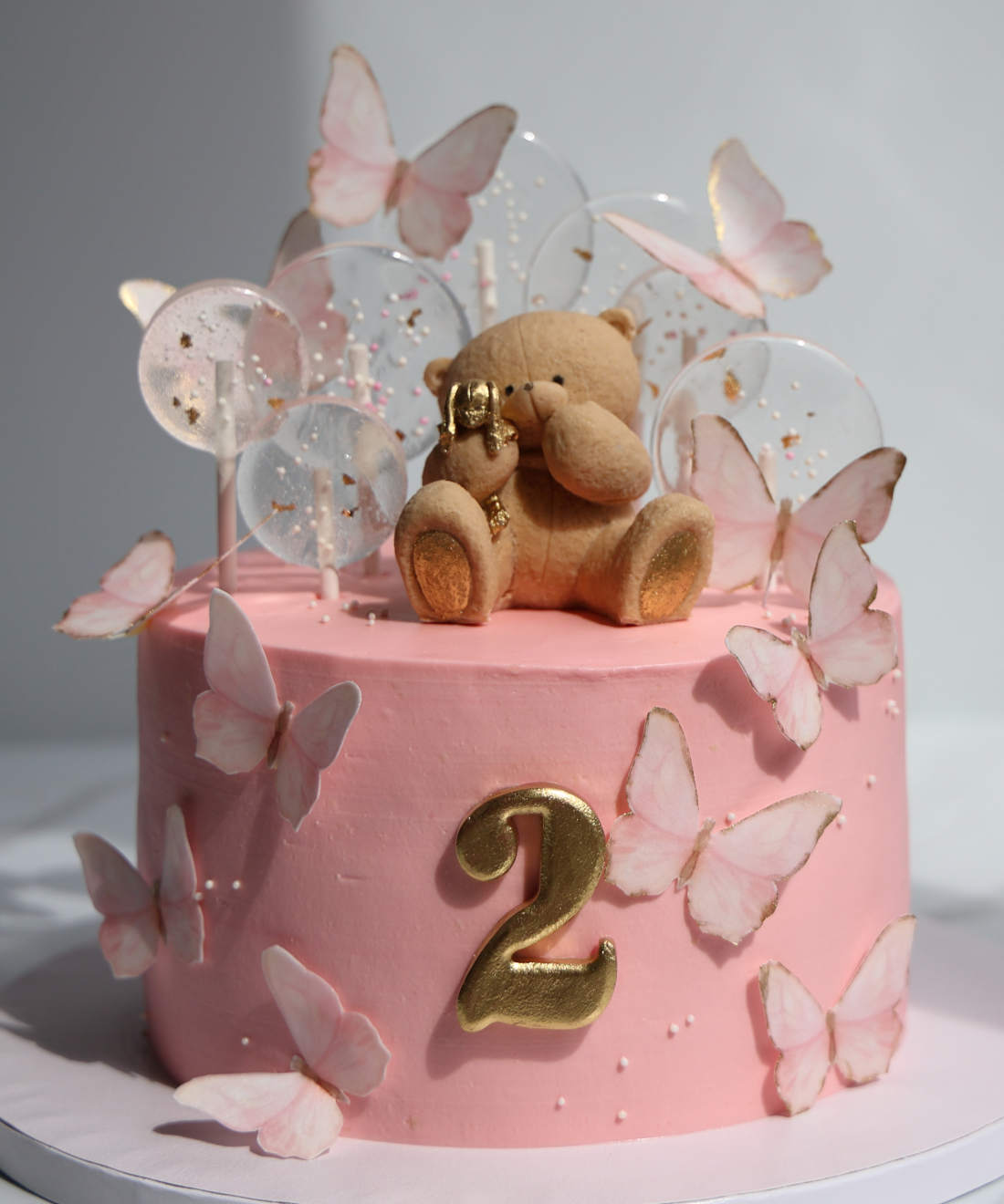 Cake with a bear and butterflies for a 2-year-old girl