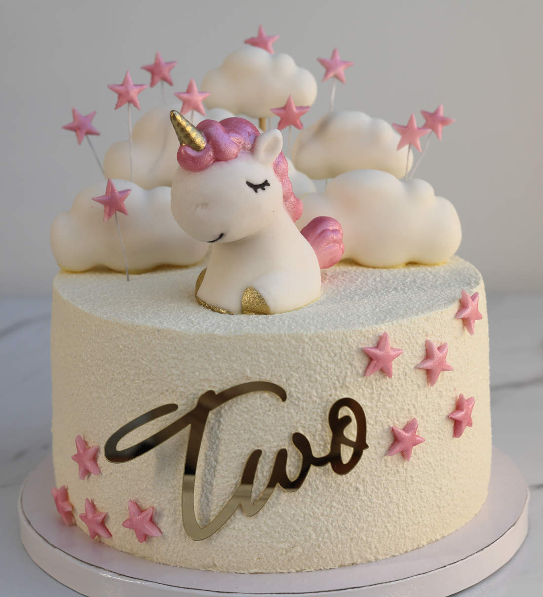 Cake with a unicorn, clouds, and stars for a 2-year-old
