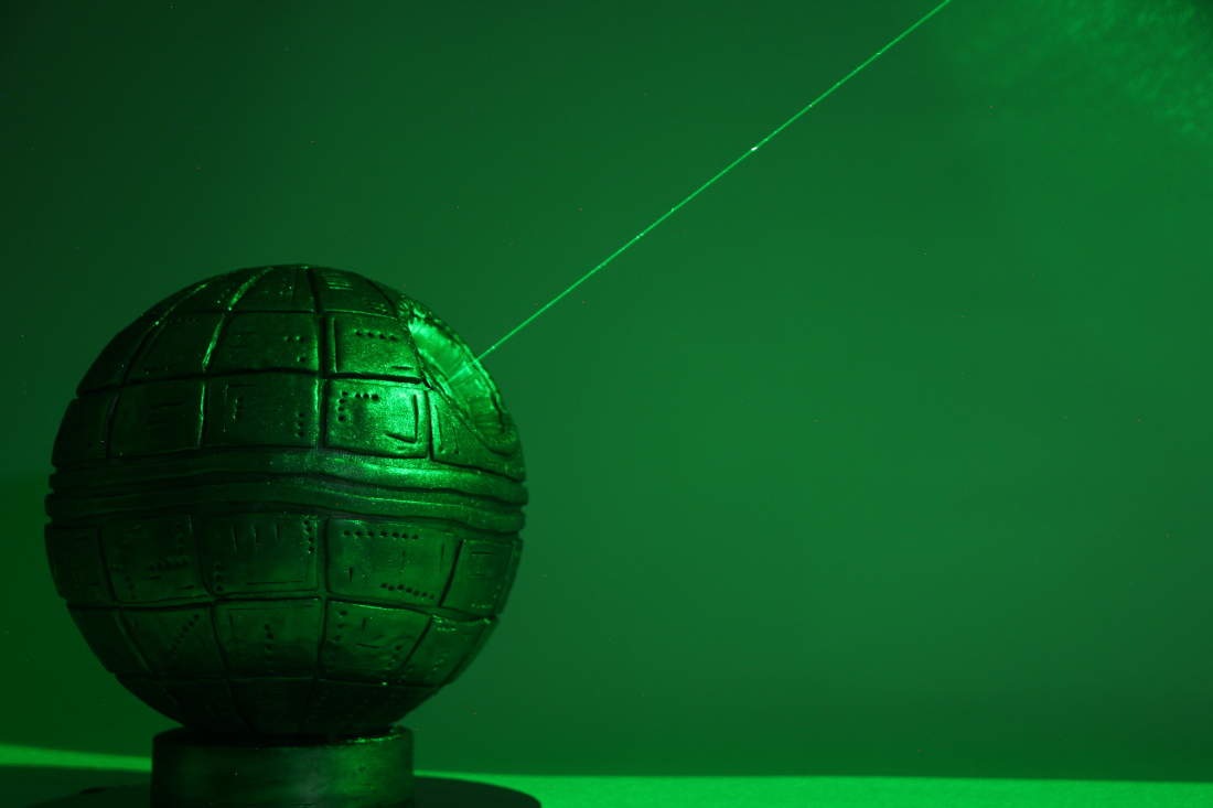 Death Star cake with green laser in the dark