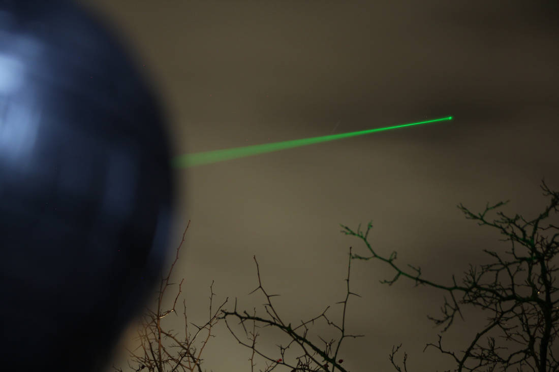 Green laser of the Death Star cake shines into the sky