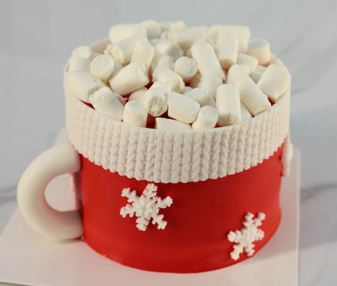 Festive bento cake in the shape of a mug with marshmallows