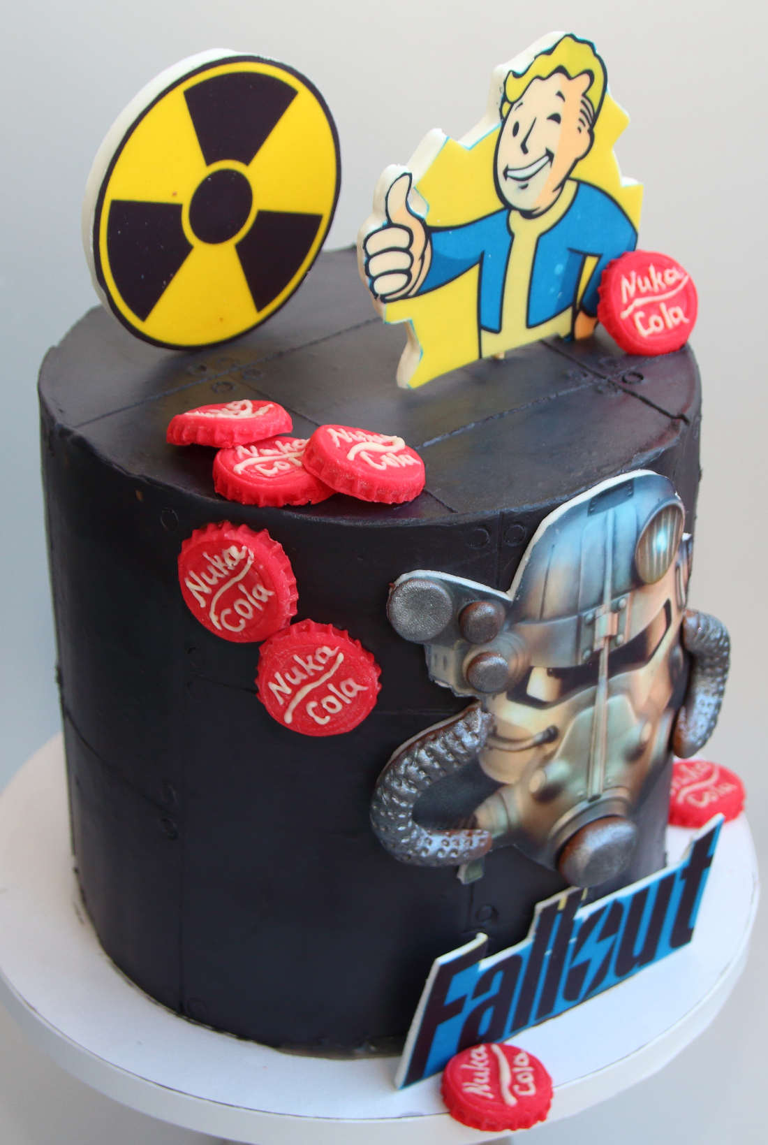 Nuka Cola caps and Brotherhood of Steel helmet on Fallout cake