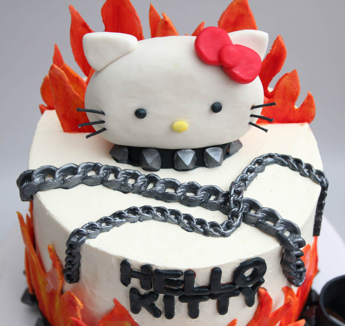 Cake with a cat, fire, chains and spikes