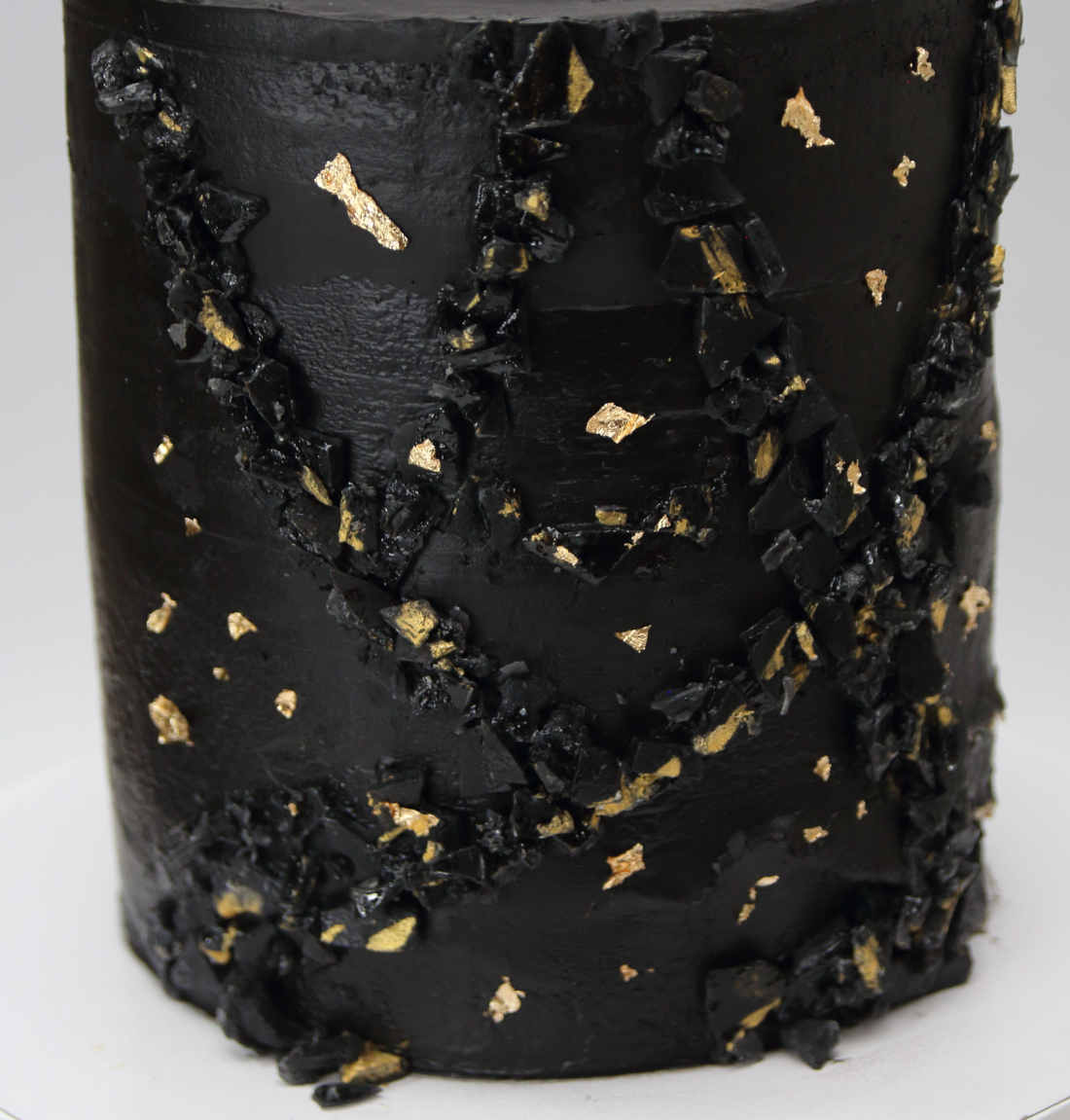 Gold particles on a black birthday cake