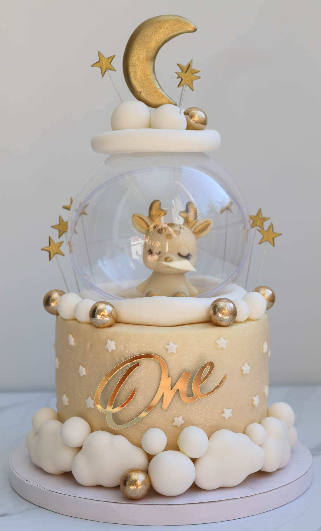 Fawn, stars, and the moon on a 1st birthday cake