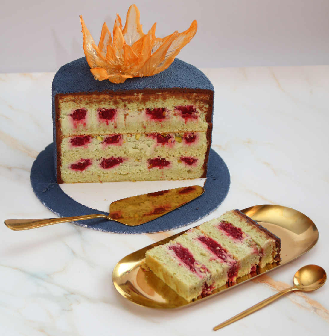 Slice the cake with raspberry and pistachio filling