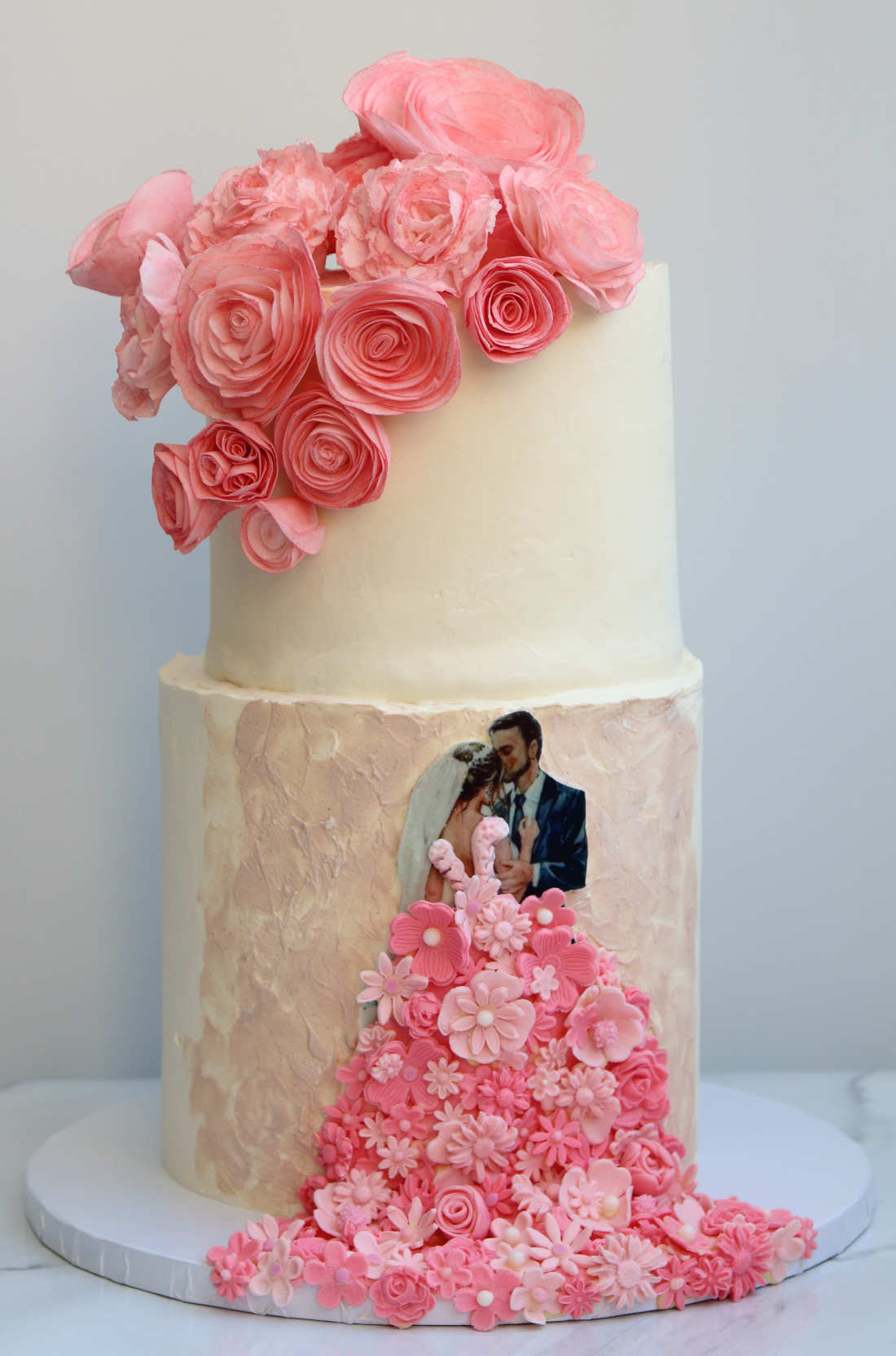 Two-tier wedding cake with flowers in Vilnius